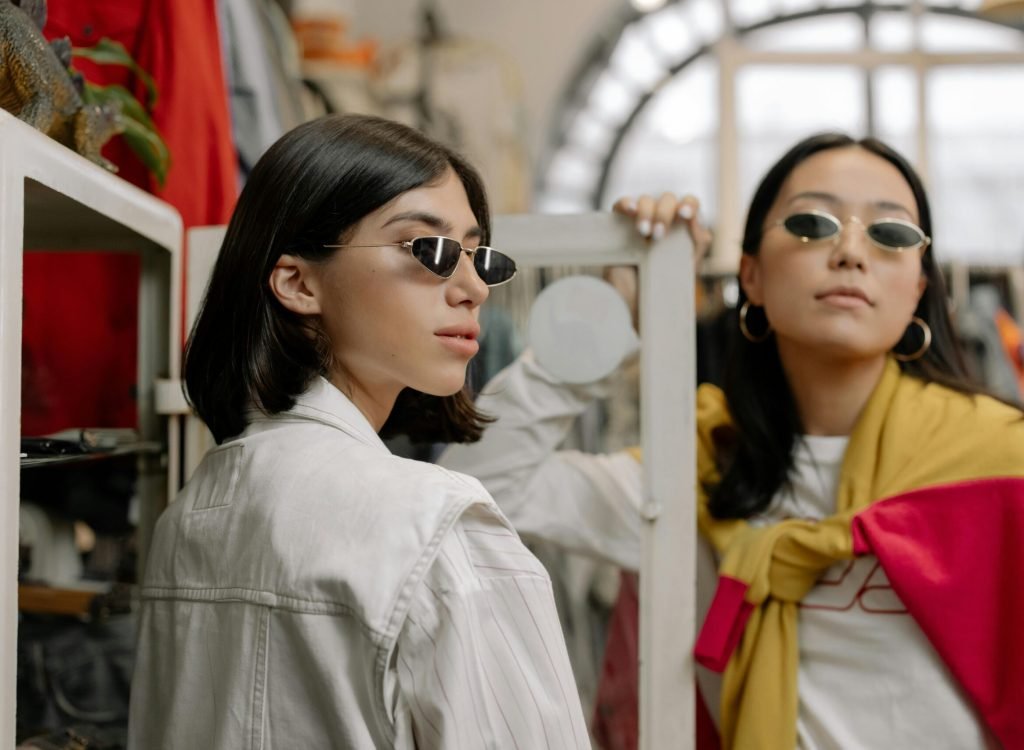 pexels-photo-6069090-6069090 Two stylish women trying sunglasses in a chic boutique setting.